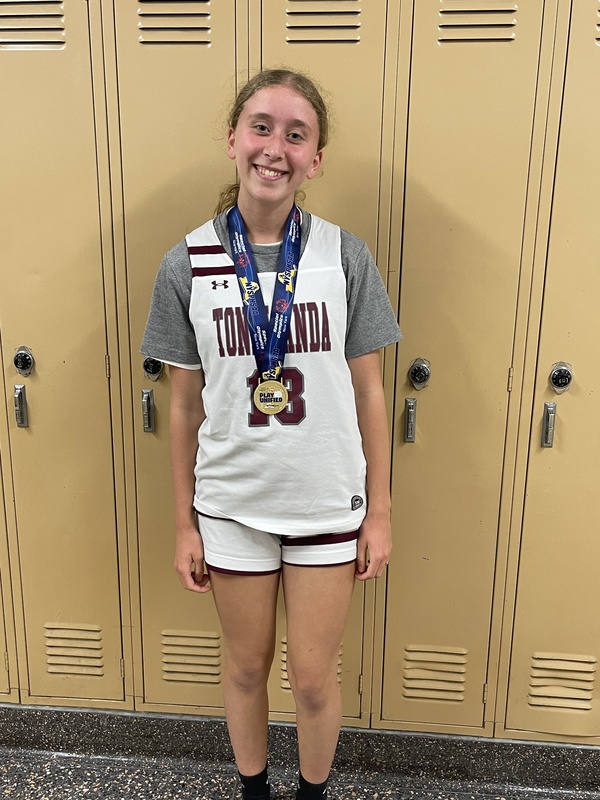 student poses with medal