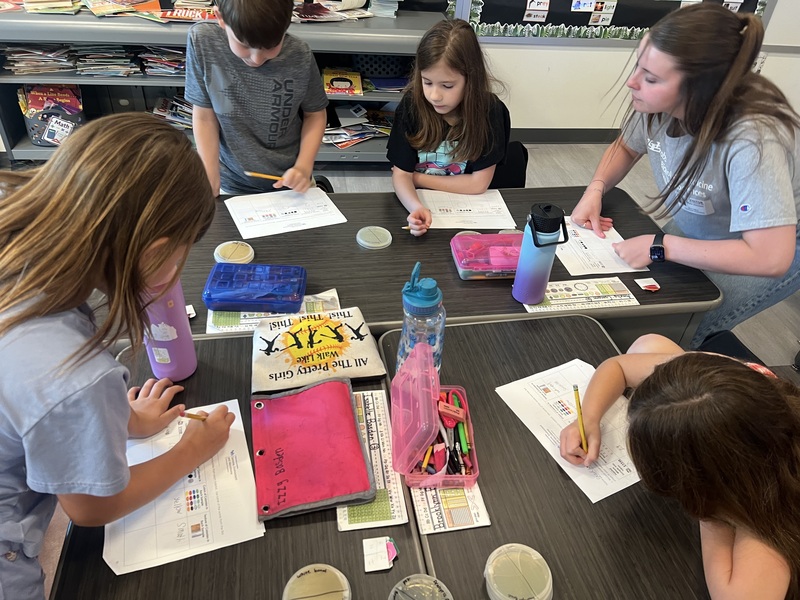students at table working on science experiments
