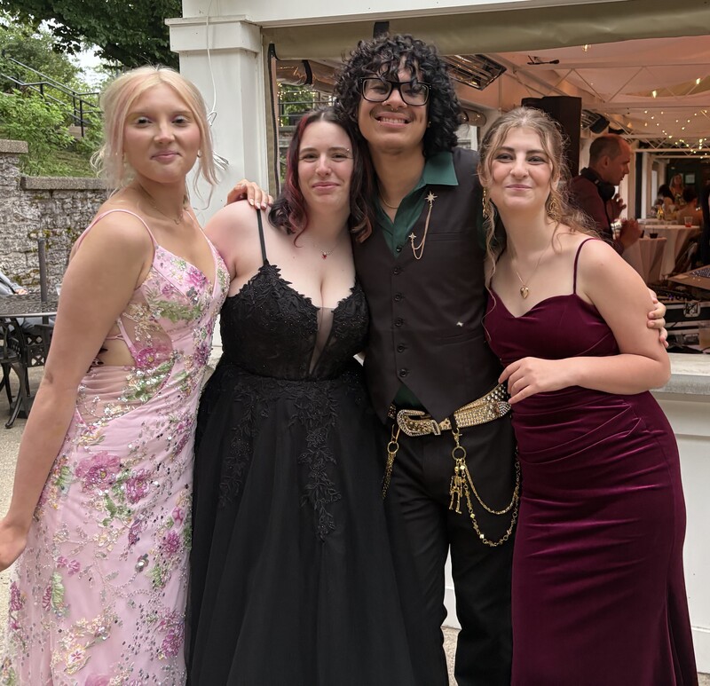 students pose in prom wear