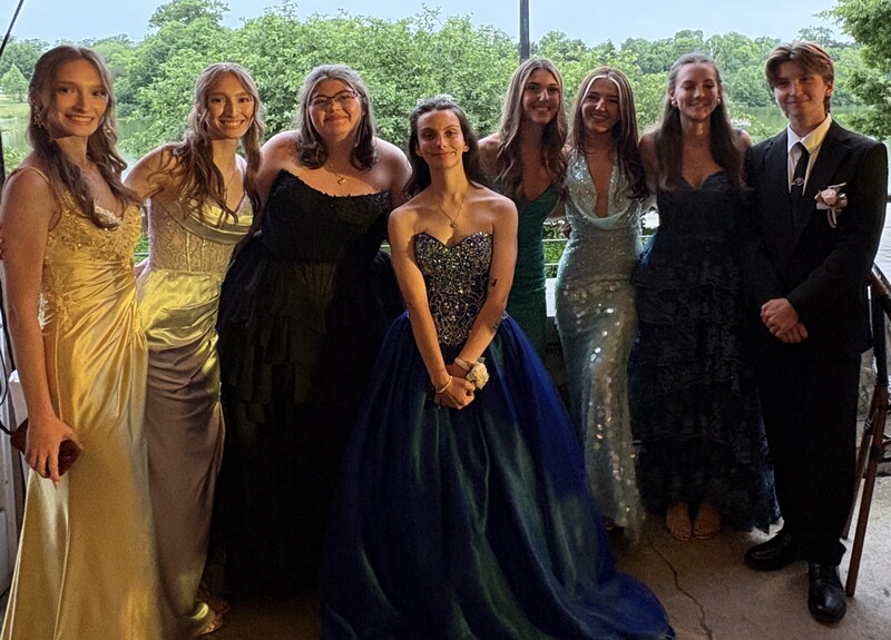 students pose inside prom venue