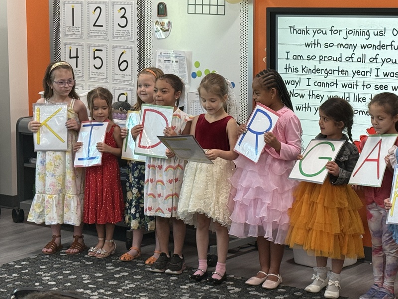 Students and families celebrate Kindergarten students. 