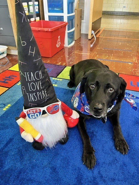 storm poses with teach love inspire hat on gnome