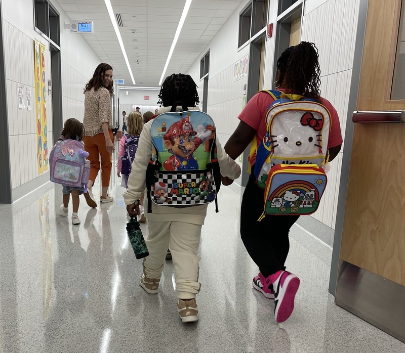students walk down hallway