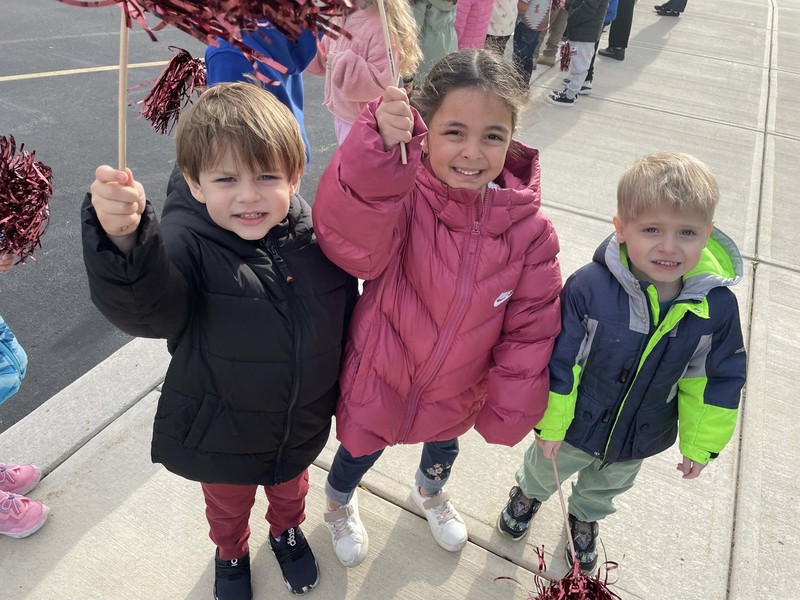 younger students cheer on the big kids in their race