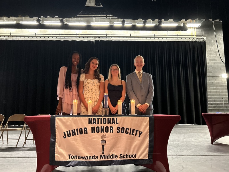 students posing behind NJHS sign