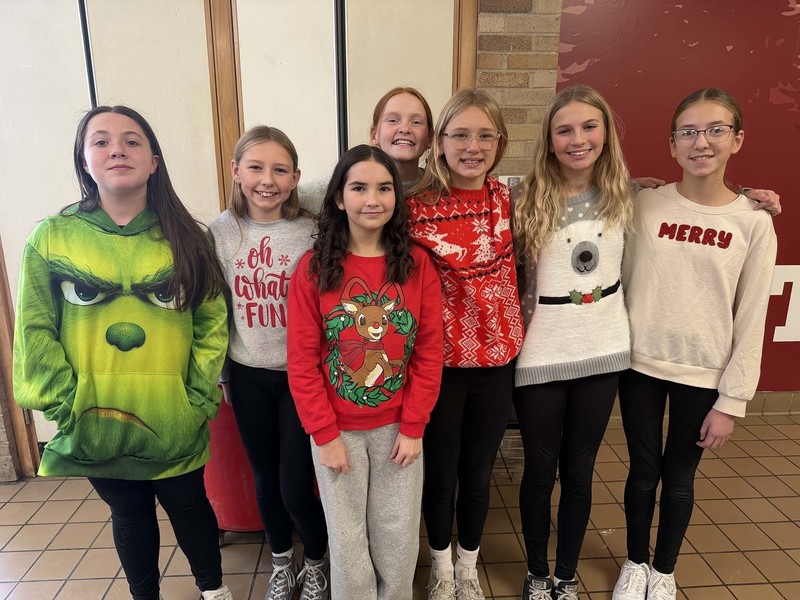 students posing in ugly christmas sweaters