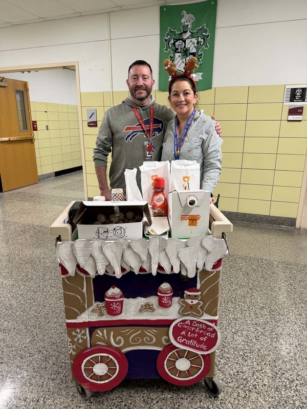 principal and assistant principal pose with cheer cart