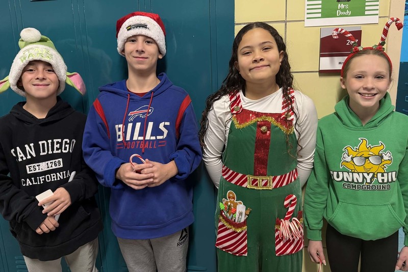 students pose in hats and holiday headbands