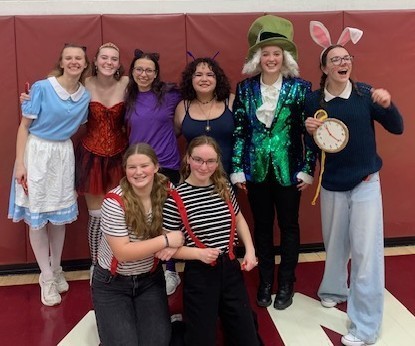 students pose in alice in wonderland outfits