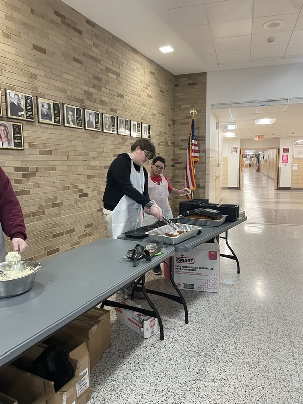 Students serve meals at Best Buddies Fish Fry.