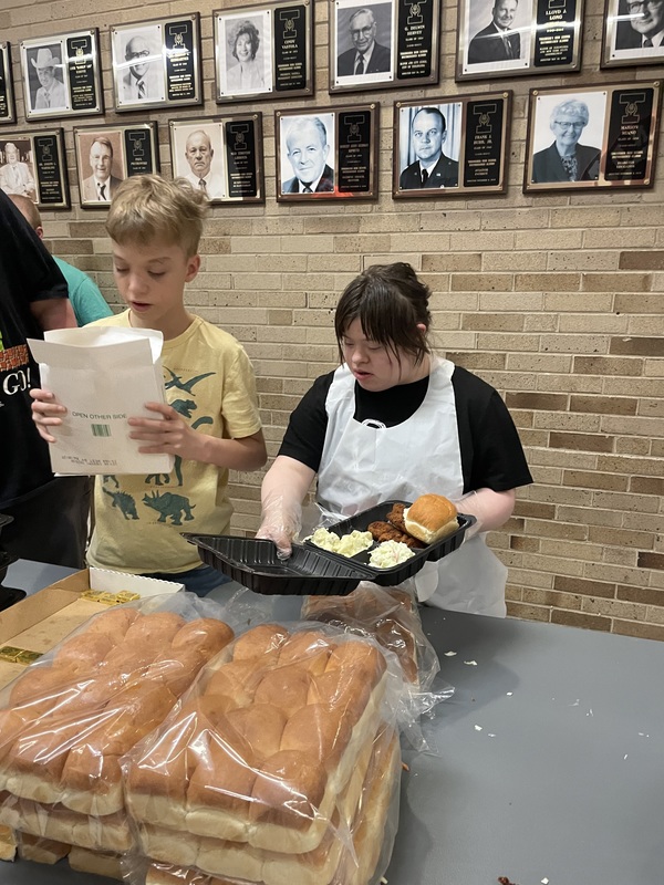 Students serve meals at Best Buddies Fish Fry.