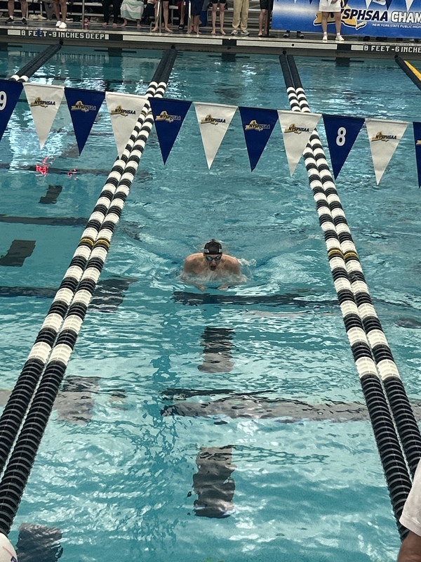 Jack swims at a meet.