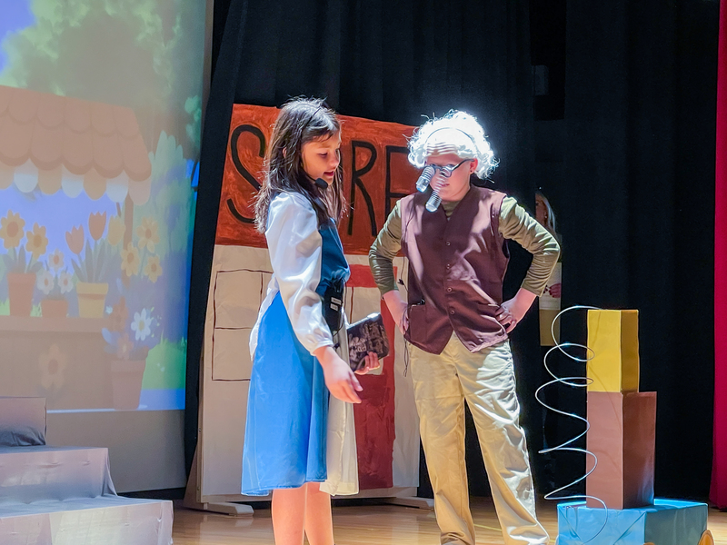 belle and her father talk on stage during beauty and the beast show