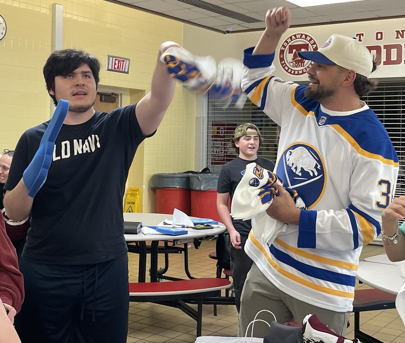 former buffalo sabre patrick kaleta shows THS best buddies student how to wave his playoff towel
