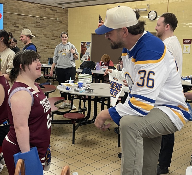 former buffalo sabre Patrick kaleta laughs with THS student 