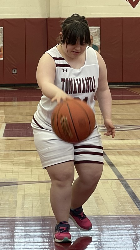 Tonawanda unified basketball player dribbles down court