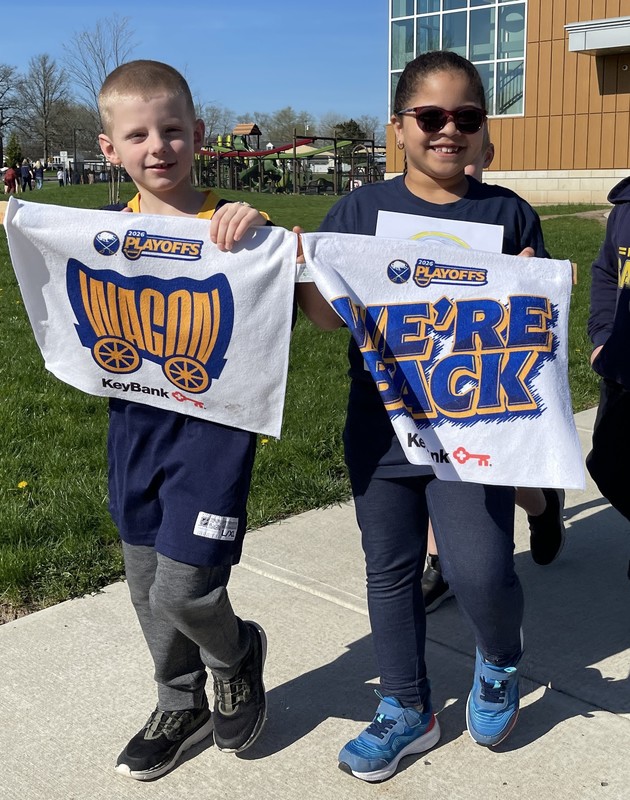 students hold up we're back buffalo sabres flags