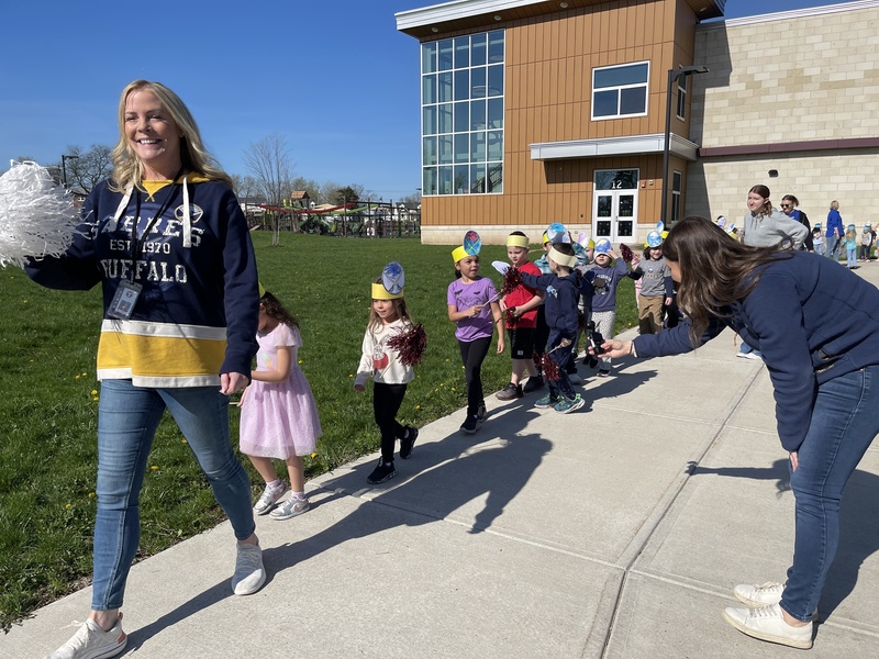 teacher leads students in sabres parade while reporter takes video