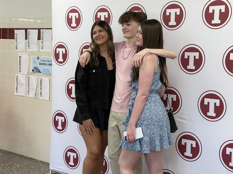 Students pose in front of Tonawanda logo backdrop