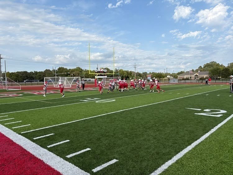 boys football playing on a turf football field