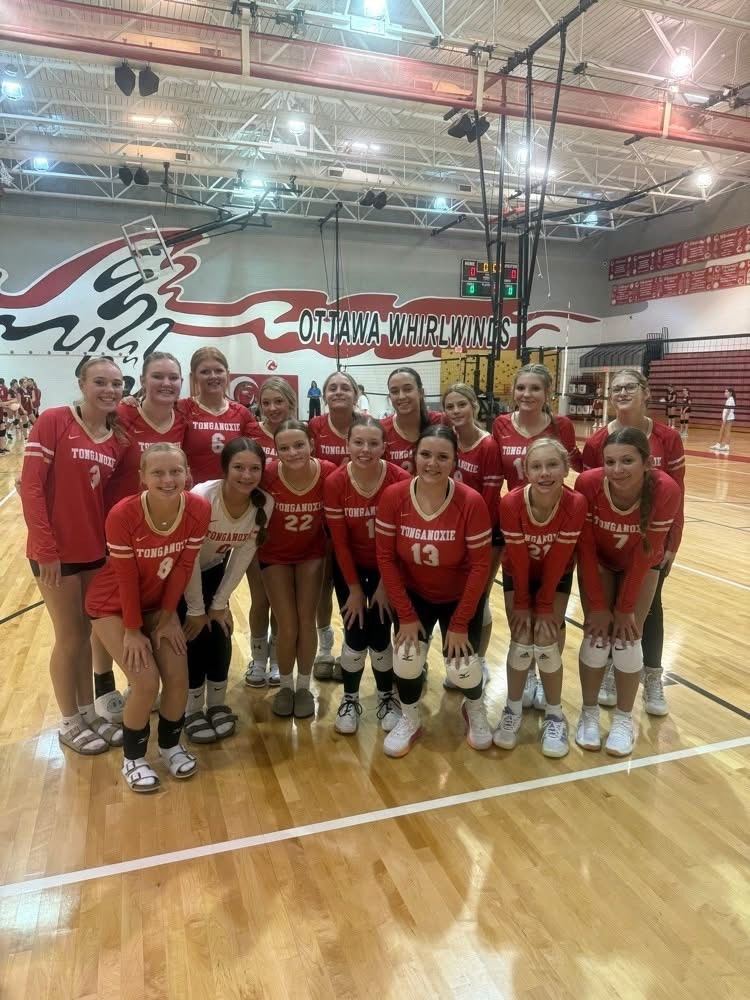 middle school volleyball players wearing red uniforms