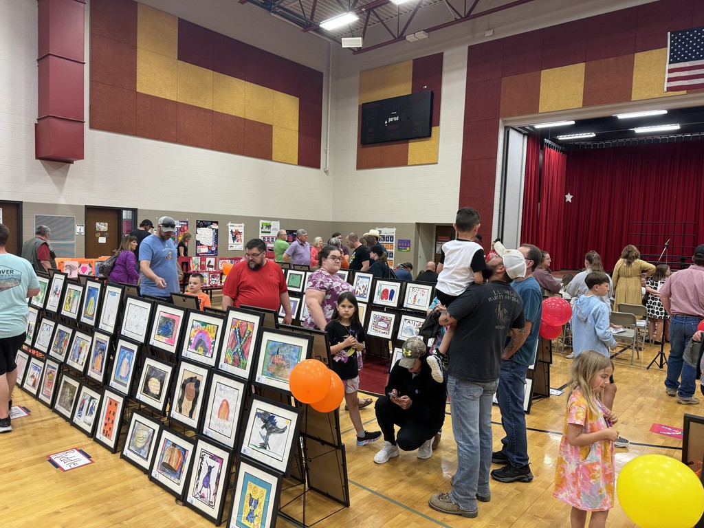 student art show with parents and students walking around looking at artwork