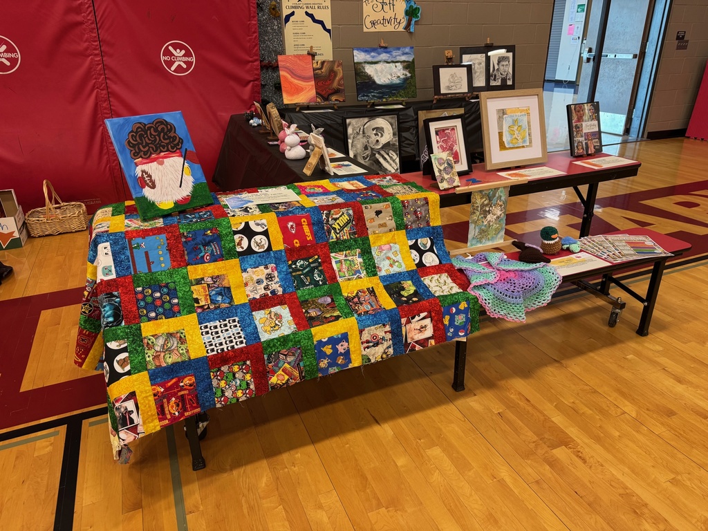colorful quilt draped over a table displaying all the squares