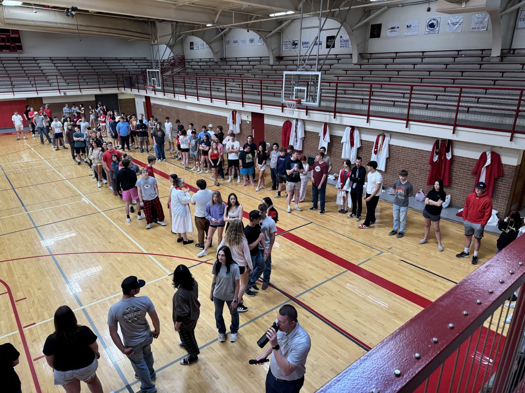 seniors line up for graduation practice in the aux gym