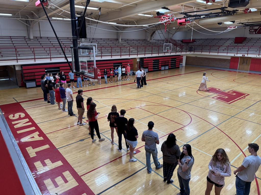 seniors line up for graduation practice in the aux gym