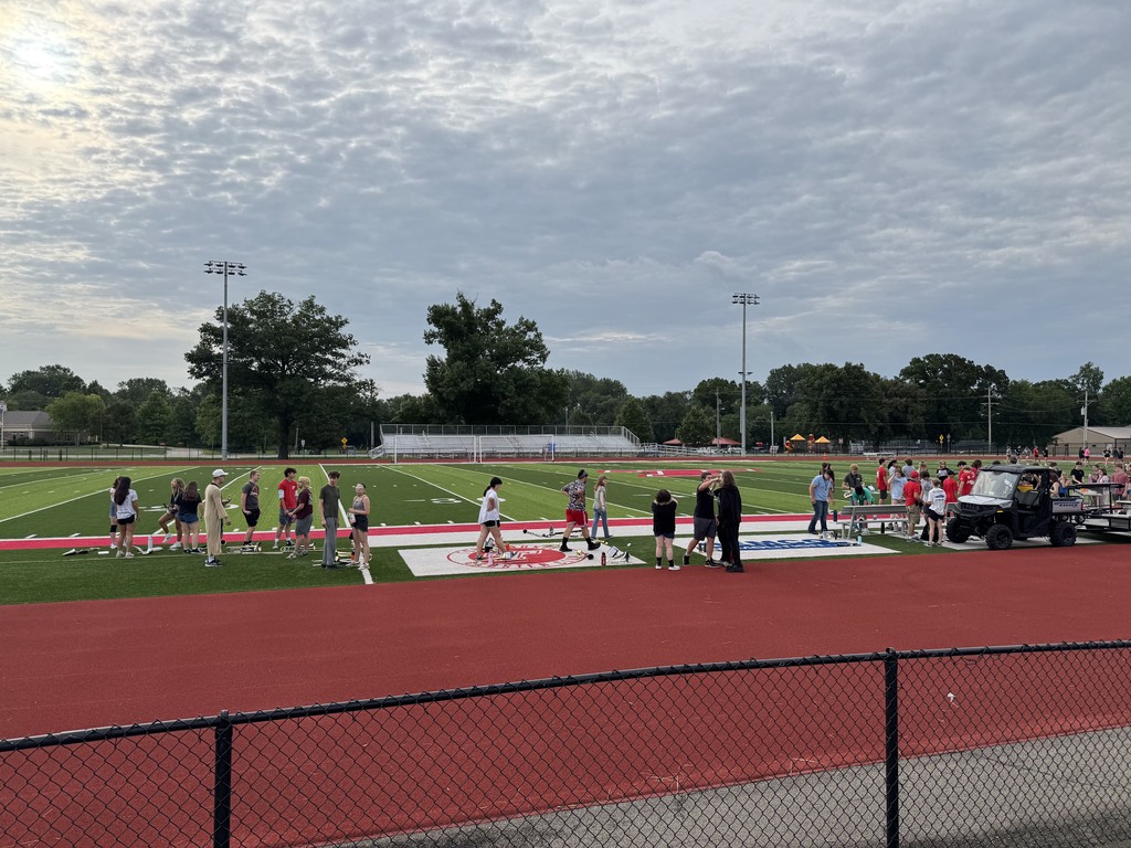 marching band members on the football field getting ready to practice