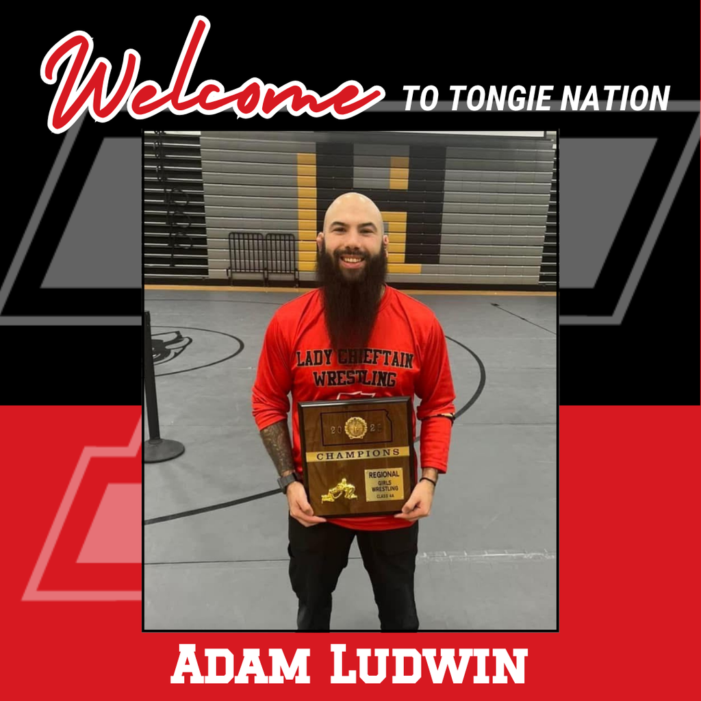 black and red background, Adam wearing black pants and red shirt, holding wooden plaque for girls wrestling regional champs