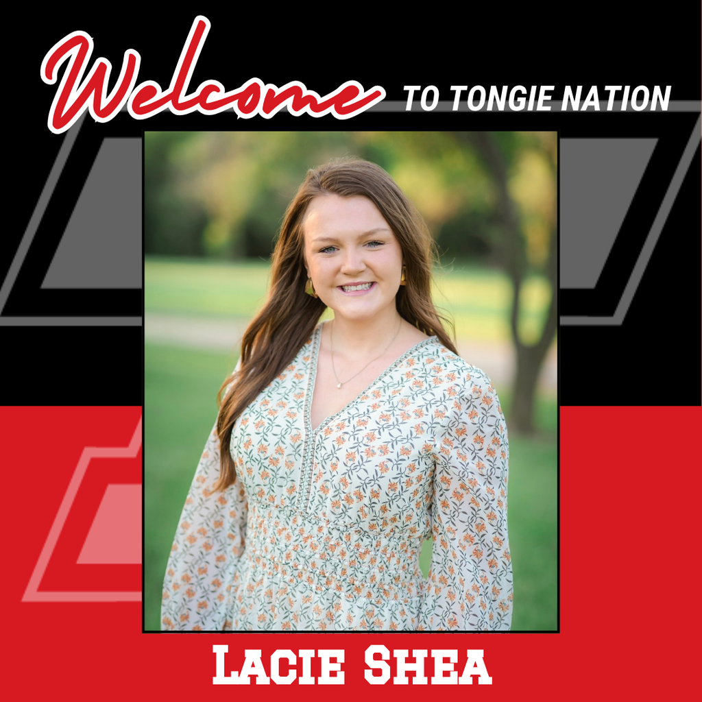 red and black background, Lacie wearing white dress with orange and green flowers on it, standing outside