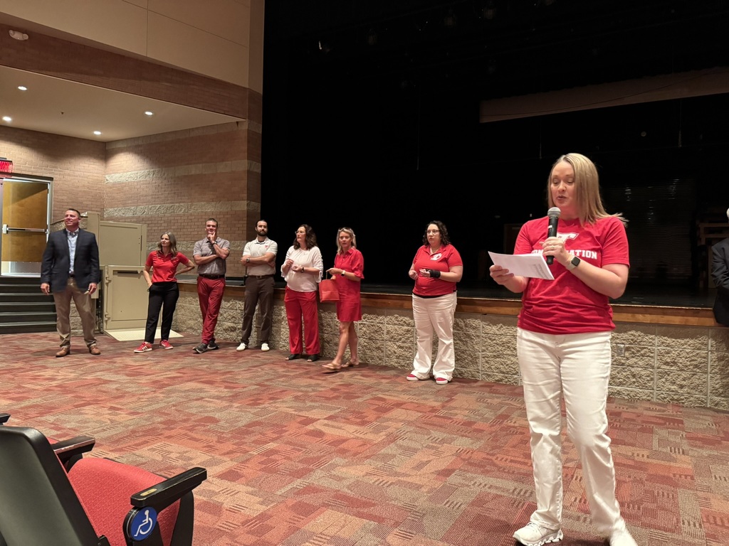Tonya Phillips speaks into a microphone as fellow administrators look on