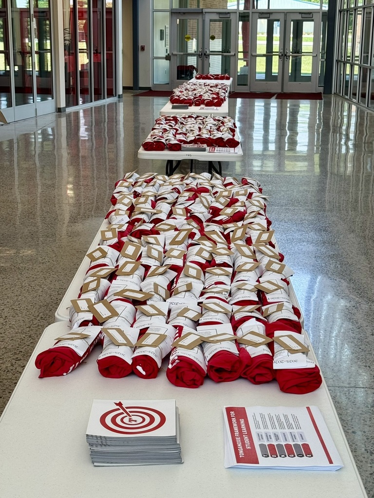 long white tables filled with red shirts