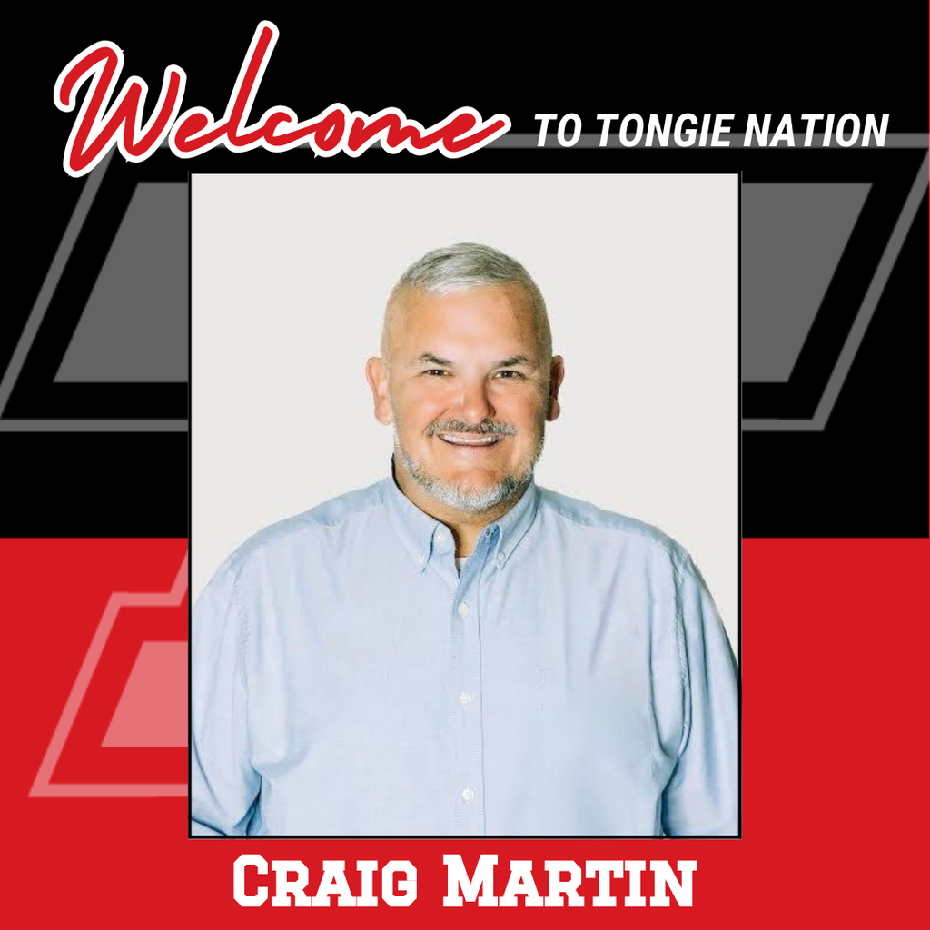red and black background, headshot of Craig Martin wearing blue button up shirt, white background
