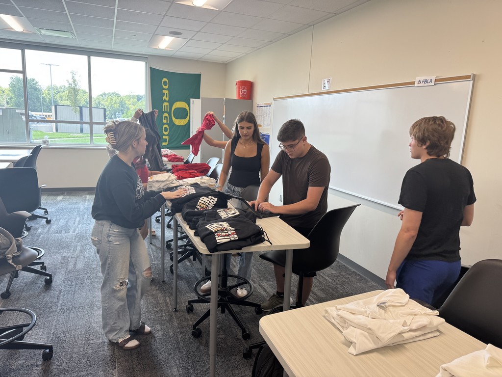 Students in 5th Period Business Applications doing inventory to prepare for the school store opening.
