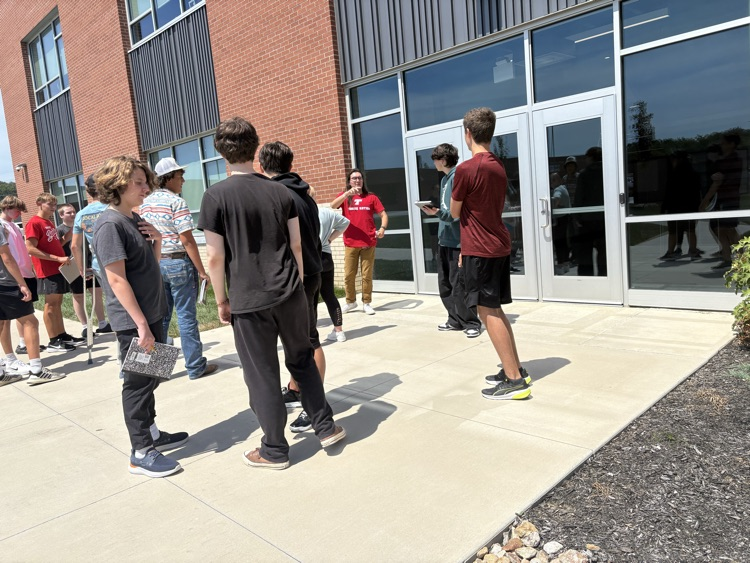 teacher brings his class outside in nature