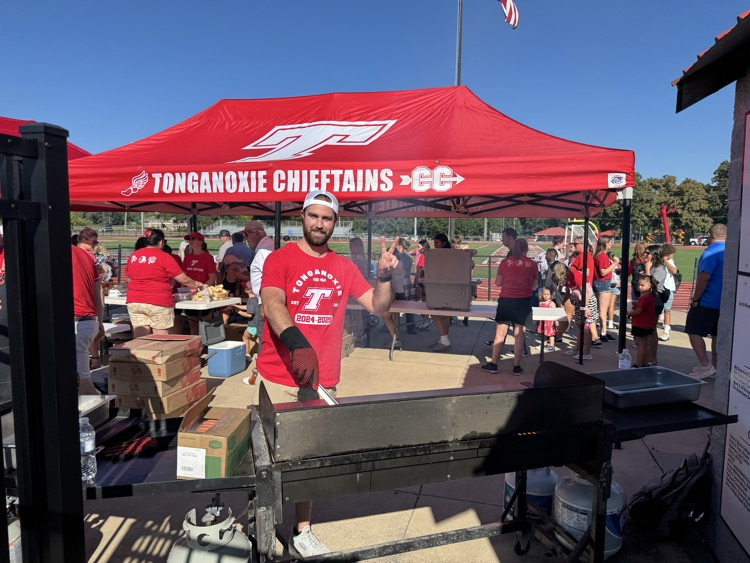 Hayes farwell grilling hot dogs on a grill