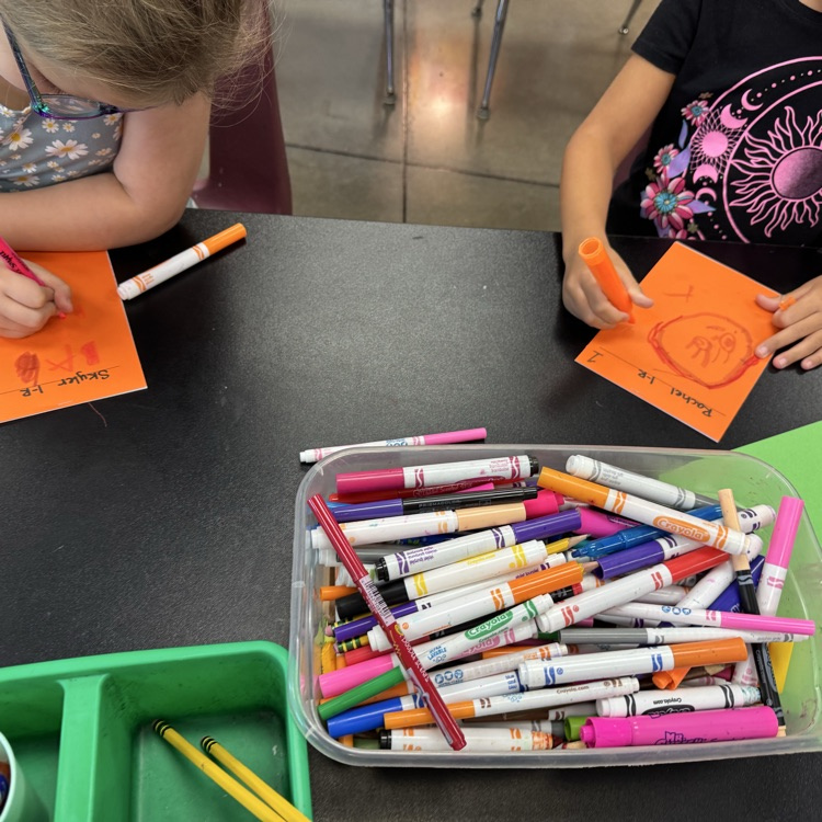 first graders drawing on sketchbook covers 