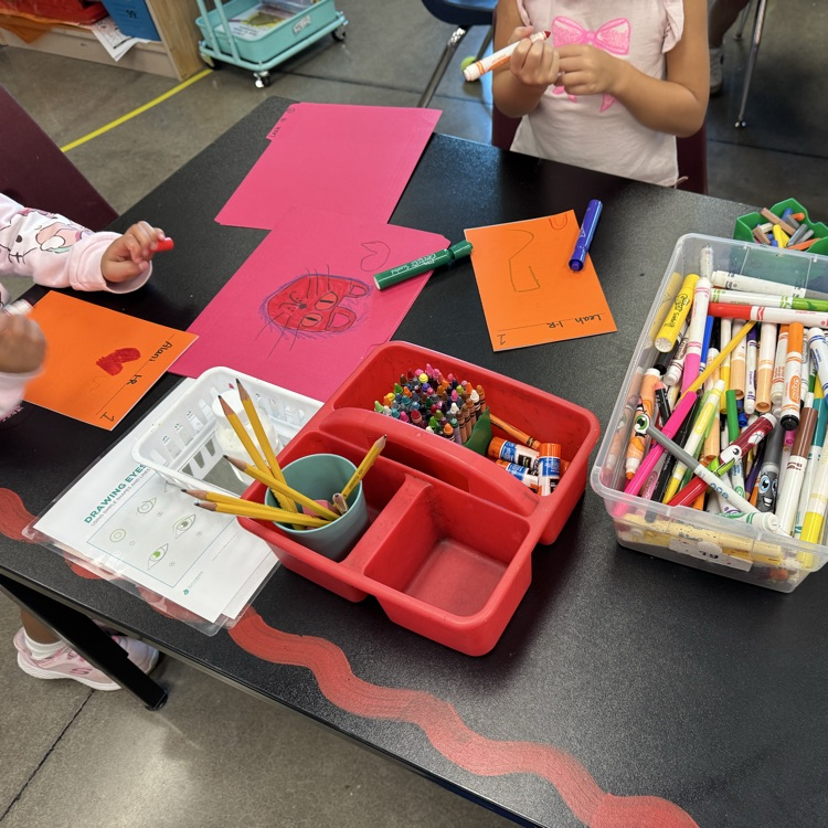 first graders drawing on sketchbook covers 
