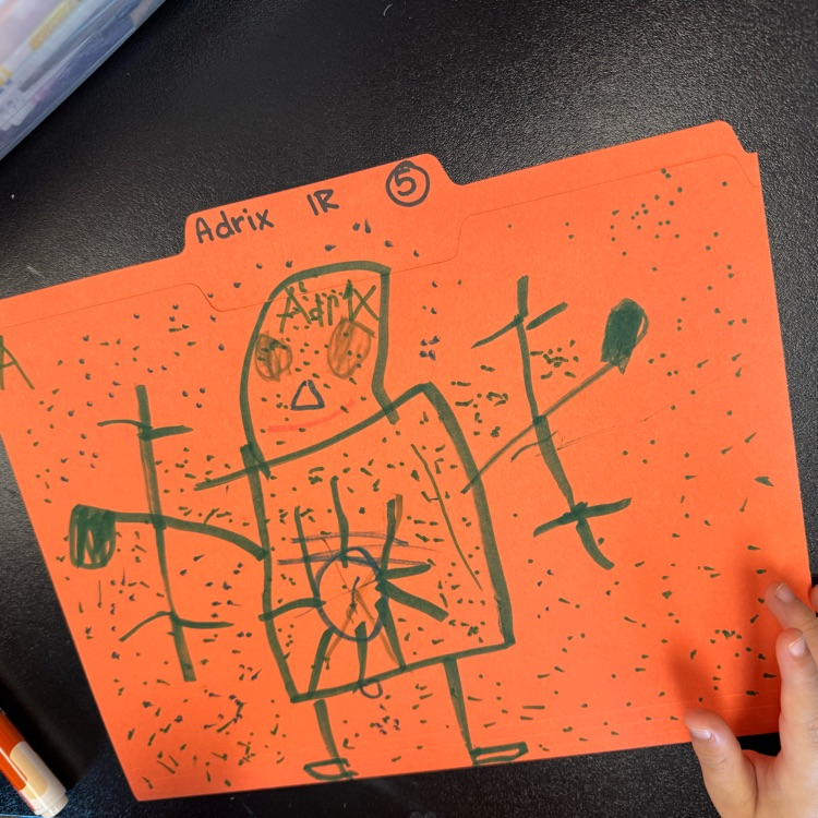 first graders drawing on folder