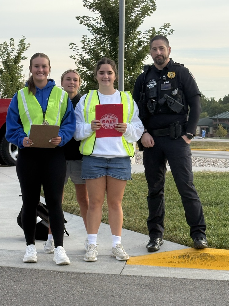 three students standing with SRO
