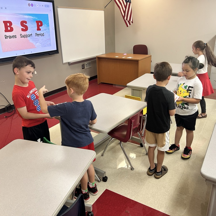Students are playing quiz quiz trade and asking each other fun questions. 