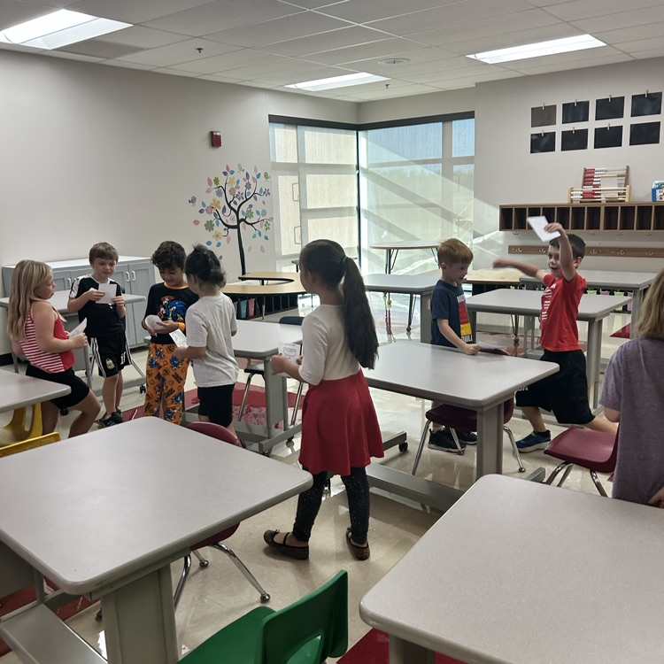 Students are playing quiz quiz trade and asking each other fun questions. 