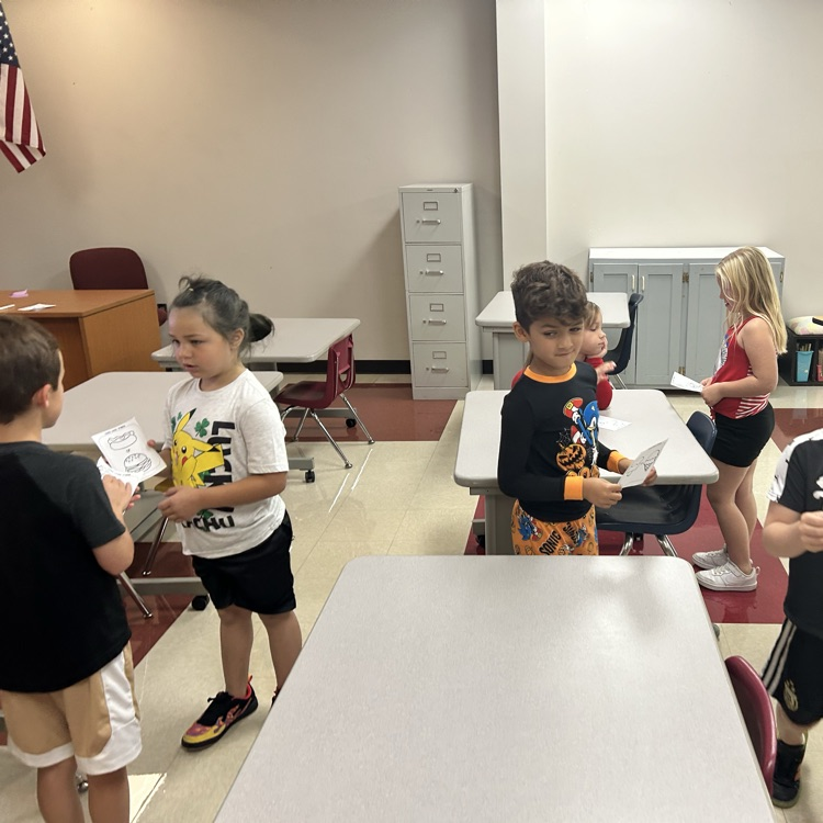 Students are playing quiz quiz trade and asking each other fun questions. 