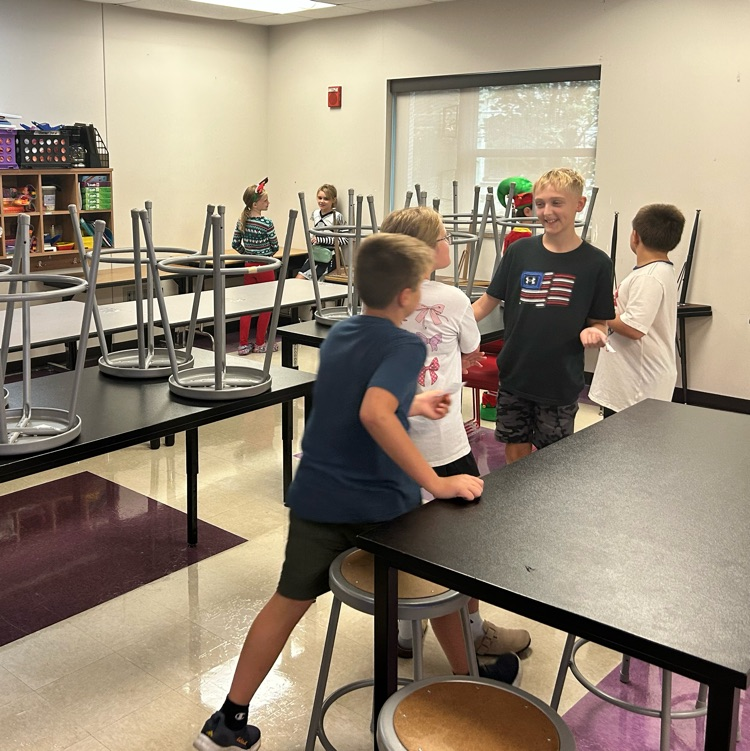 Students are playing quiz quiz trade and asking each other fun questions. 