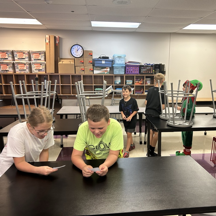 Students are playing quiz quiz trade and asking each other fun questions. 