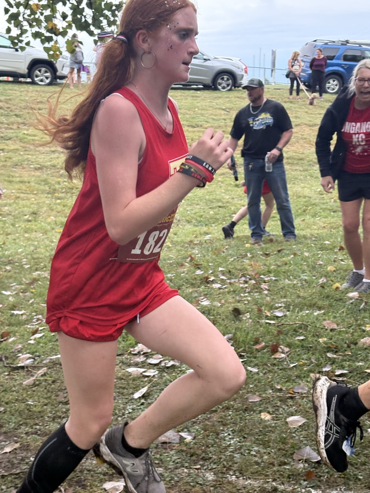 Lennon runs in a red uniform, pumping her arms.