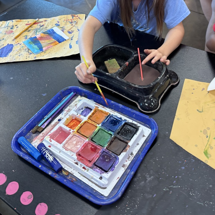 student painting with tempera cakes