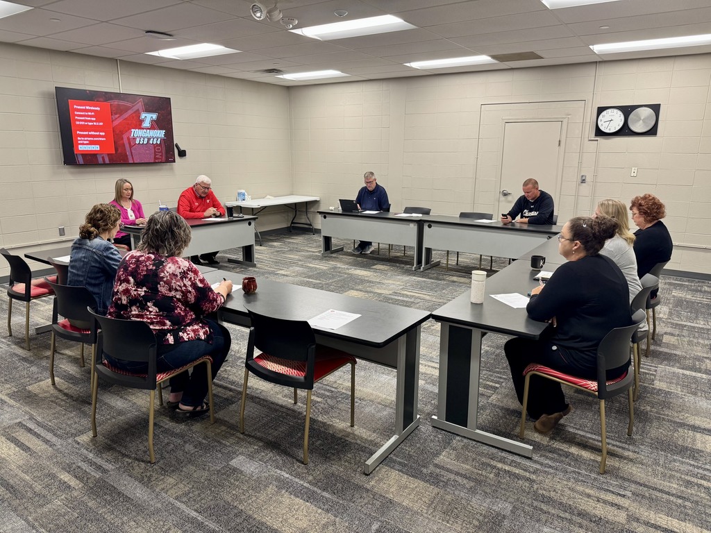 district office staff sitting at black rectangle tables, arranged in a U shape